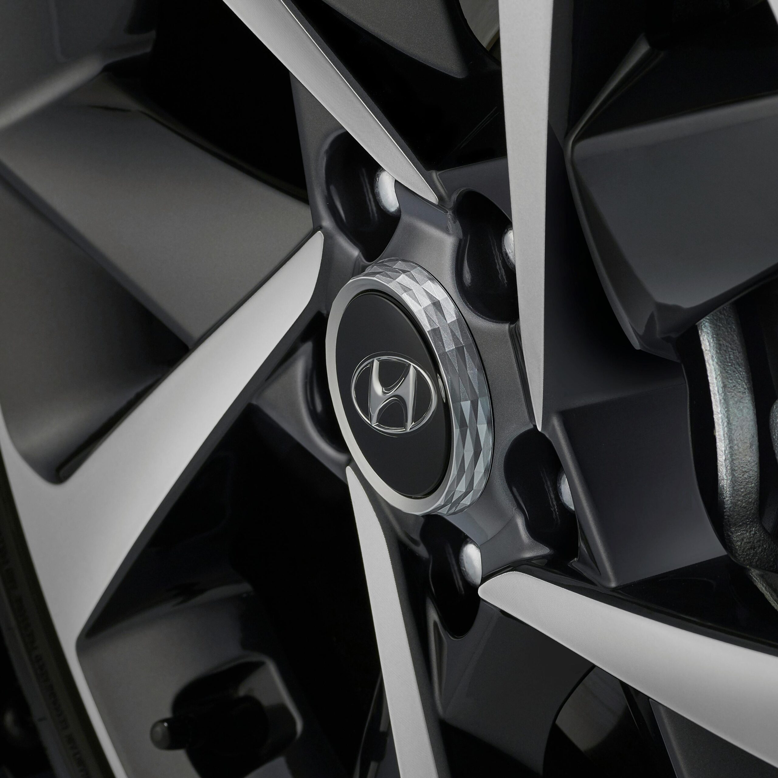 Detailed close-up of a Hyundai wheel rim showcasing the intricate design and logo.